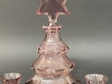 a pink glass christmas tree with a star of david on it