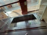 a sink in the middle of a kitchen with a window