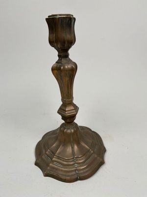 a brass candle holder on a white background with a white background