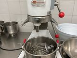 a mixer and a bowl on the counter in the kitchen