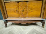 a wooden cabinet that has a mirror on top of it
