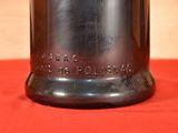 a silver bell on a red cloth on a table