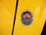the emblem of a yellow car is shown on the side of the car