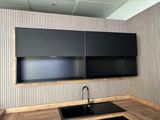 a kitchen with a sink and black cabinets in it