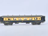 a blue and yellow train car with people on it