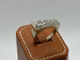 an image of a diamond ring on a wooden stand