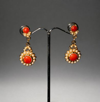 a pair of coral and pearl earrings