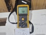a yellow and black meter sitting on top of a white table