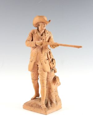 figurine of a man with a gun and a dog