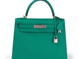 a green leather handbag on a white background