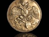 a close up of a gold coin with an eagle on it
