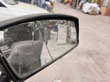 a side view mirror of a car in a warehouse