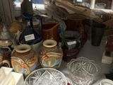 many different vases and bowls on the table