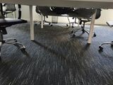 tables and chairs in an office with a view of a window