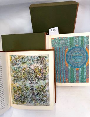three books that are open on a white surface