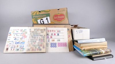 a lot of books and a box of stamps on a table
