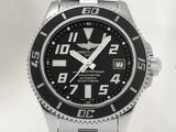 a close up of a watch on a white surface