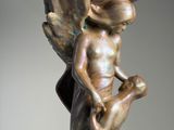 statue of an angel holding a globe on his back