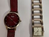 two watches sitting next to each other on a table