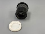 a close up of a camera lens sitting on a table next to a plastic cup