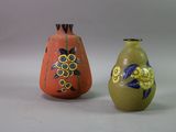 two vases sitting next to each other on a white surface
