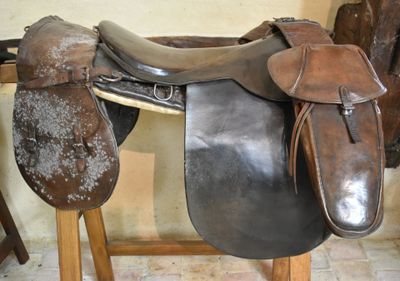 a saddle that is sitting on a stand in a room