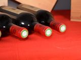 several bottles of wine are lined up on a red table