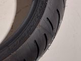 a close up of a motorcycle tire on a white surface