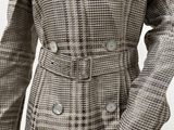 a close up of a mannequin wearing a plaid coat with buttons
