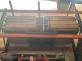 a large stack of wood on a shelf in a garage