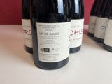 several bottles of wine are lined up on a table