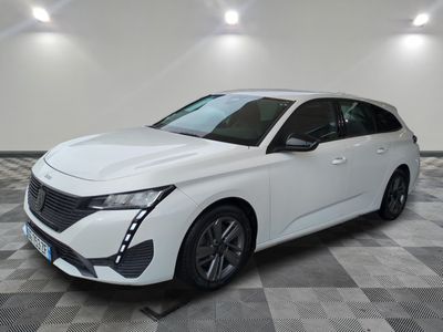 a white car is parked in a large room with checkered floor