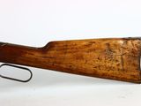 an old rifle with a wooden barrel and a metal handle