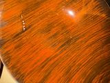 a wooden bowl sitting on top of a table next to a pair of scissors