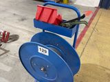 a blue hose on a cart in a garage