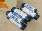 four rolls of toilet cleaner sitting next to a bottle of toilet cleaner