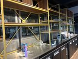a metal counter with a bunch of glasses on it