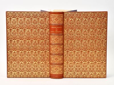 an old book with a brown cover sitting on top of a white table