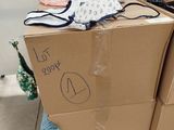 a cardboard box that has some clothes on top of it
