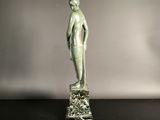 bronze statue of a man standing on a marble base