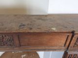 a very old wooden desk with carvings on top of it