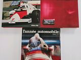 three books on a table with a racing car in front of them