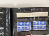 a person holding a black wallet with stamps in it