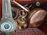 a red basket with a clock, a clock, and other items in it