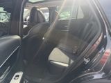 a black car with the door open and the seats down