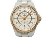 a white watch with gold hands on a white bracelet
