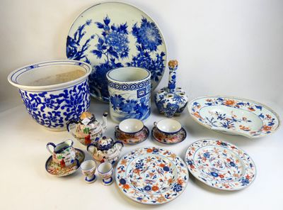many pieces of blue and white pottery on the table