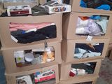 several boxes of clothing are stacked on top of each other in a room