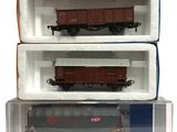 two boxes of toy train cars are stacked on top of each other