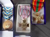 three medals in a box on a table